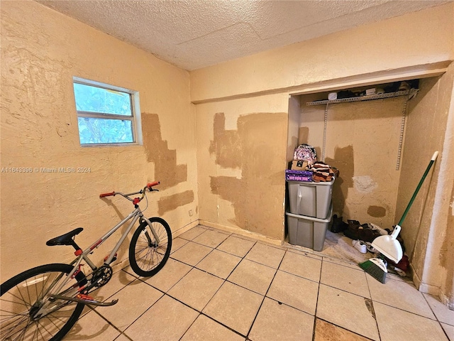 miscellaneous room featuring tile patterned flooring and a textured ceiling