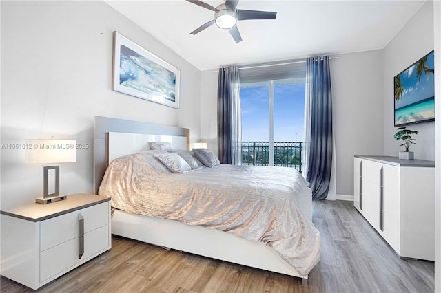 bedroom featuring light hardwood / wood-style floors, ceiling fan, and access to outside