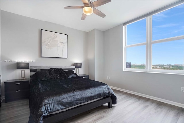 bedroom featuring ceiling fan and light hardwood / wood-style flooring