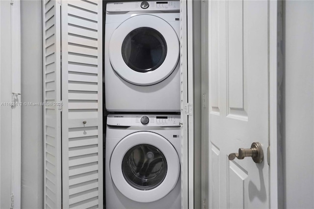 laundry area featuring stacked washer / drying machine