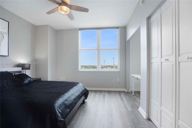 bedroom featuring ceiling fan and light hardwood / wood-style flooring