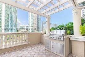 view of patio with exterior kitchen and a grill