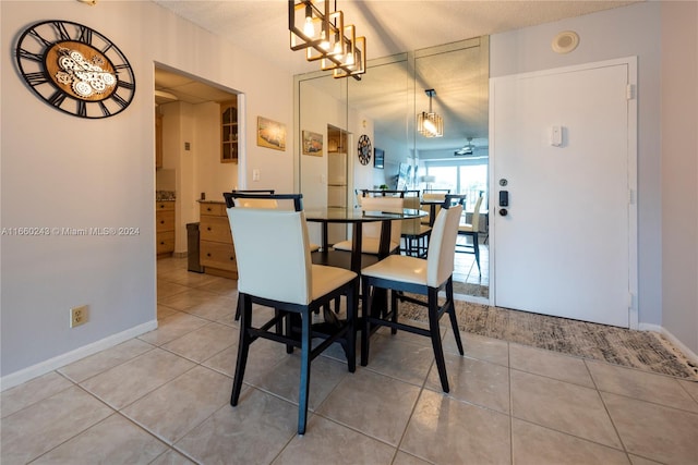 dining room featuring a textured ceiling, a chandelier, and tile patterned floors