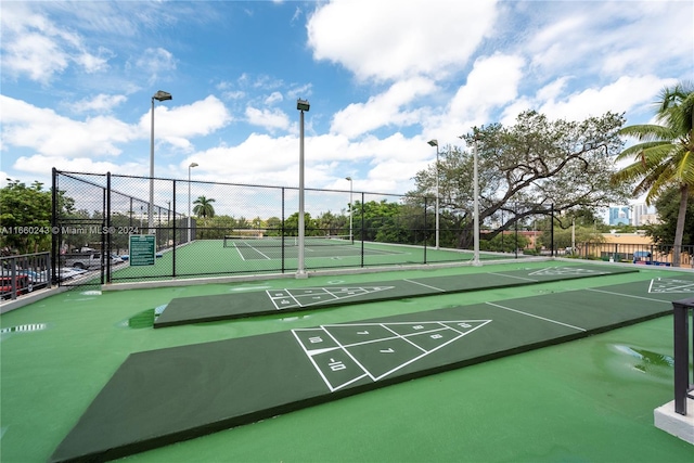 view of community featuring tennis court