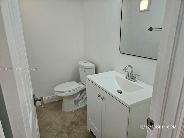 bathroom featuring tile patterned floors, vanity, and toilet