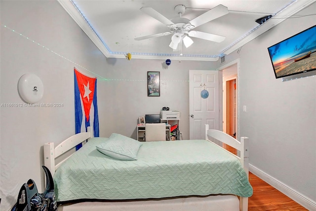 bedroom featuring wood-type flooring, ceiling fan, and crown molding