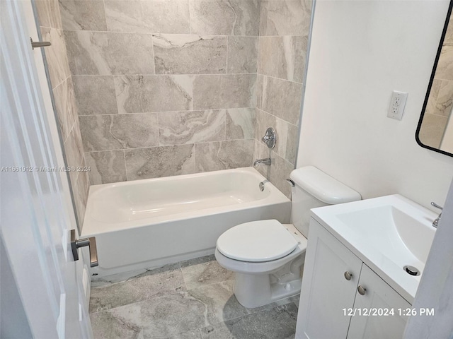 full bathroom featuring tiled shower / bath combo, toilet, and vanity