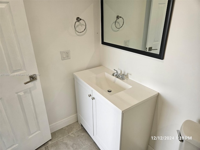 bathroom featuring tile patterned floors, vanity, and toilet