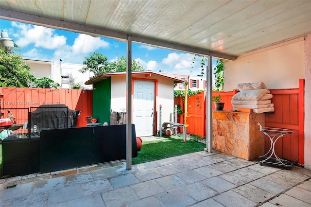 view of patio featuring a storage shed