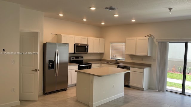 kitchen with white cabinetry, recessed lighting, stainless steel appliances, a center island, and a sink