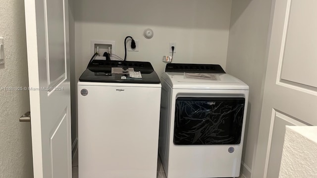 clothes washing area featuring washing machine and dryer