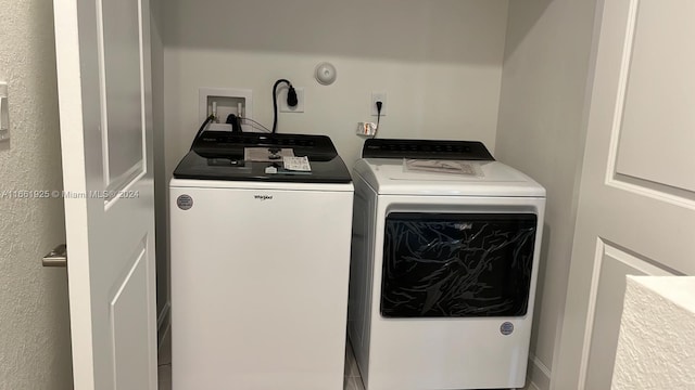 clothes washing area with washing machine and dryer and laundry area