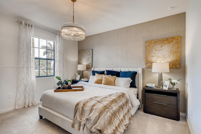 bedroom with an inviting chandelier and light carpet