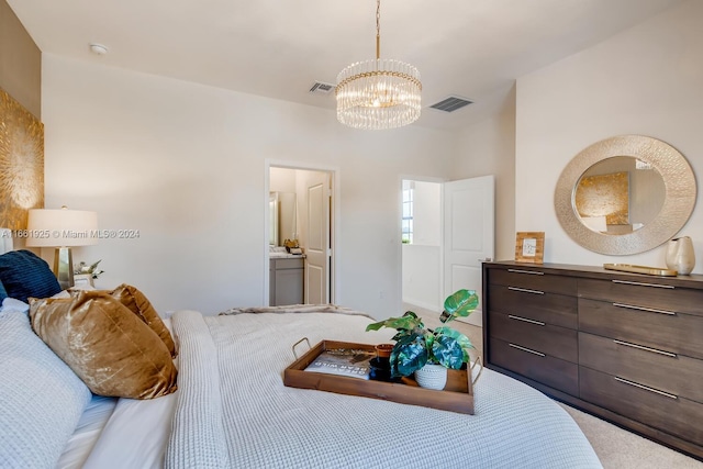 carpeted bedroom with connected bathroom and a chandelier