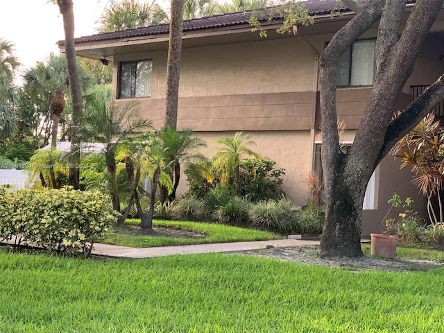 view of side of property with a lawn