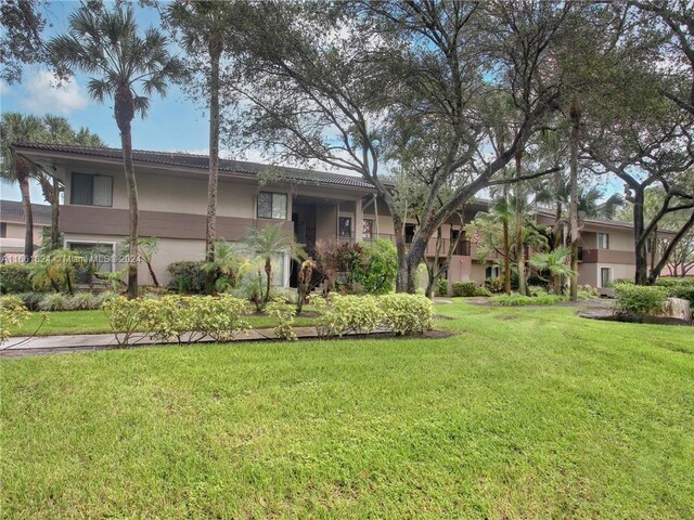 9549 NW 2nd Pl Unit 1-C, Coral Springs, FL 33071 - view of front of home featuring stucco siding and a front lawn