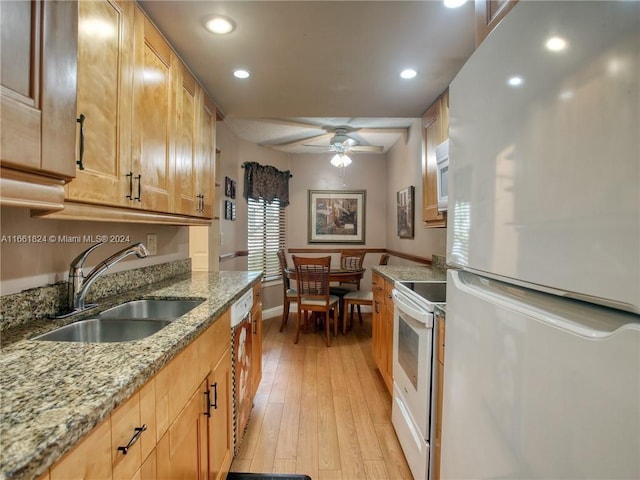 kitchen with light wood-type flooring, sink, white appliances, light stone countertops, and ceiling fan