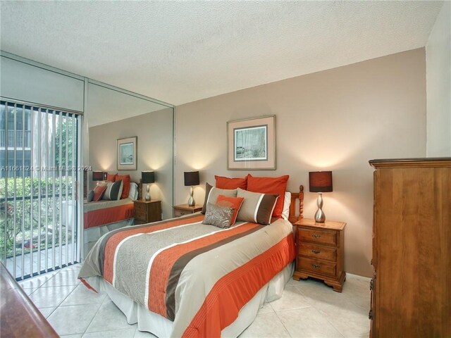 9549 NW 2nd Pl Unit 1-C, Coral Springs, FL 33071 - bedroom featuring a textured ceiling, light tile patterned floors, and access to exterior