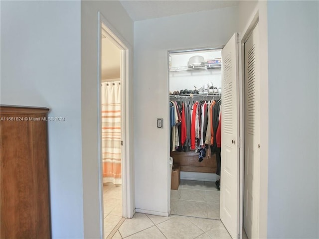 corridor featuring light tile patterned floors