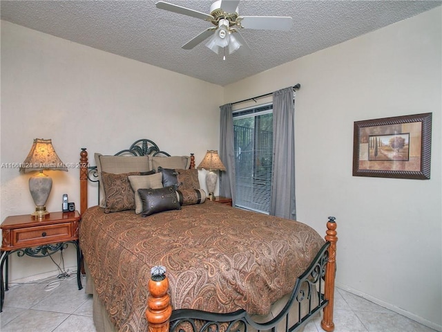 bedroom featuring a textured ceiling, light tile patterned floors, and ceiling fan