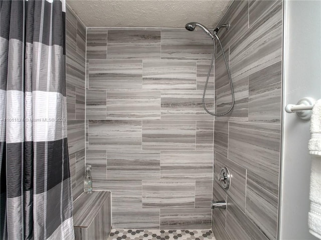 bathroom with walk in shower and a textured ceiling