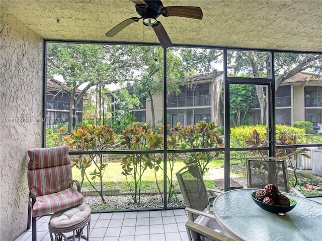 unfurnished sunroom featuring ceiling fan