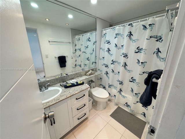 bathroom with tile patterned flooring, curtained shower, vanity, and toilet