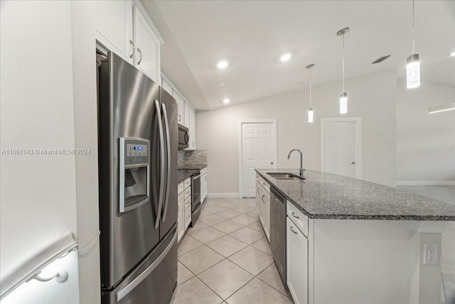 kitchen featuring appliances with stainless steel finishes, white cabinetry, lofted ceiling, a center island with sink, and sink