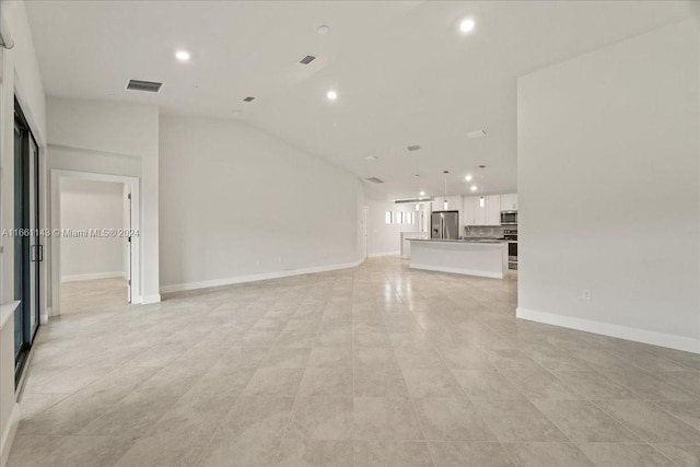 unfurnished living room with vaulted ceiling