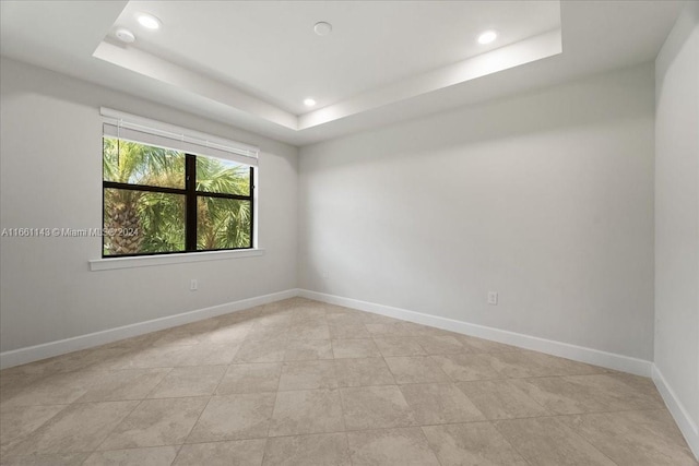 unfurnished room with a raised ceiling