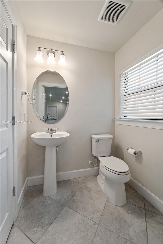 bathroom with tile patterned flooring and toilet