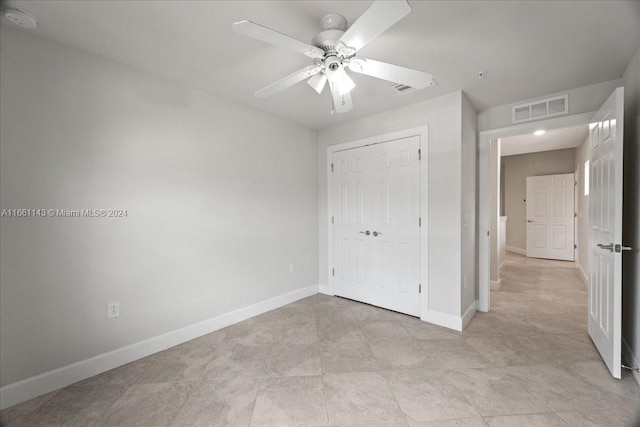 unfurnished bedroom featuring a closet and ceiling fan