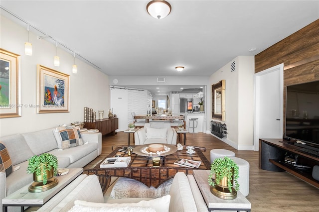 living room featuring wood walls and hardwood / wood-style flooring