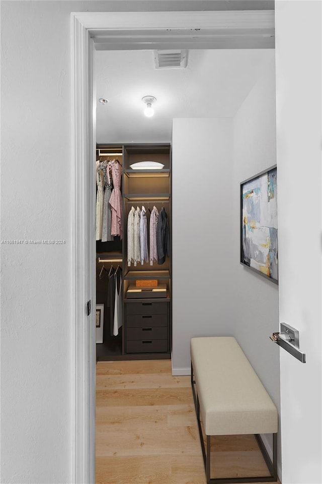 walk in closet featuring light hardwood / wood-style flooring