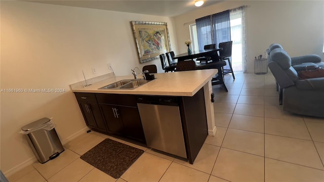 kitchen with sink, dishwasher, and light tile patterned floors