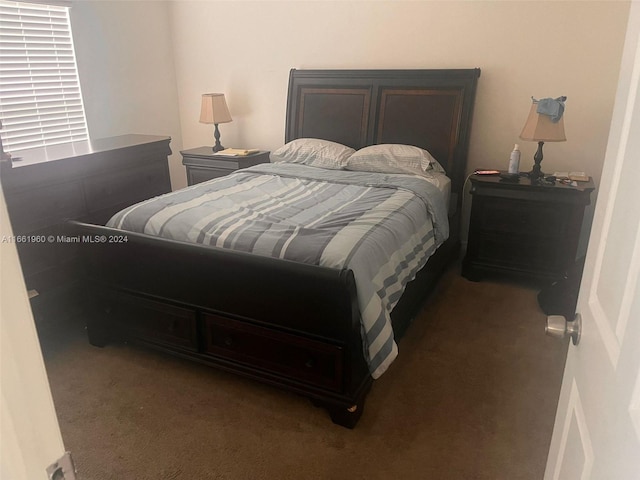 bedroom with dark colored carpet