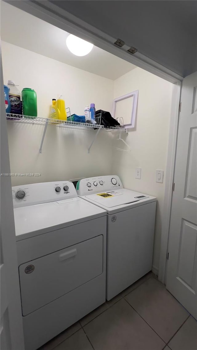 laundry area featuring washing machine and dryer and tile patterned flooring