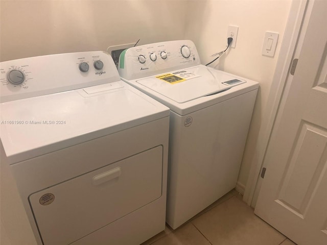 washroom featuring light tile patterned flooring and separate washer and dryer