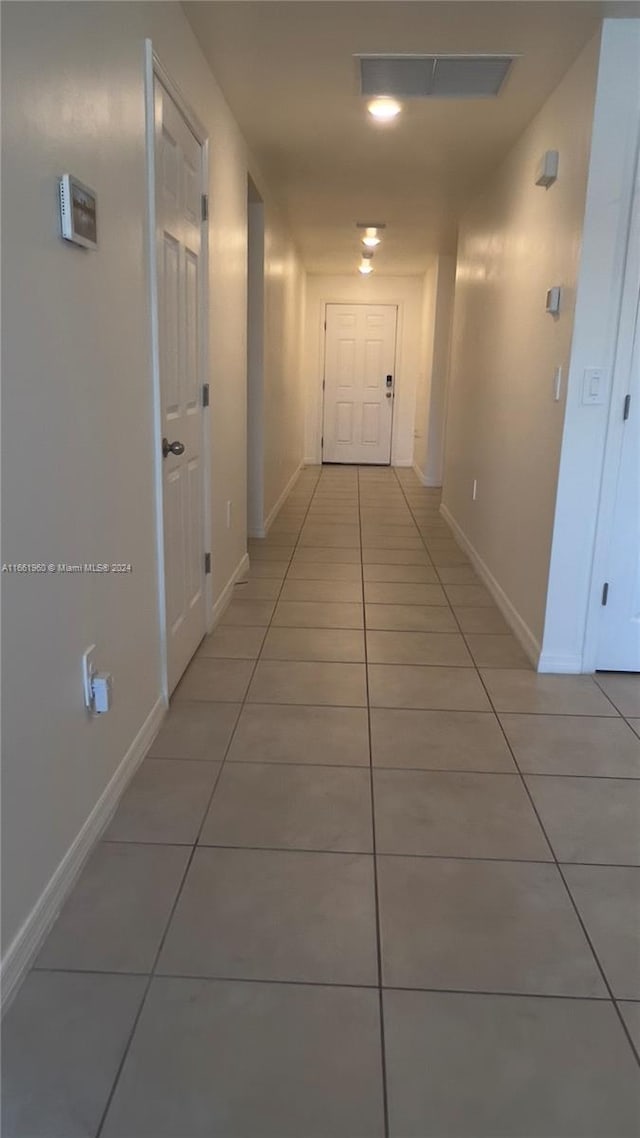 hallway featuring light tile patterned floors