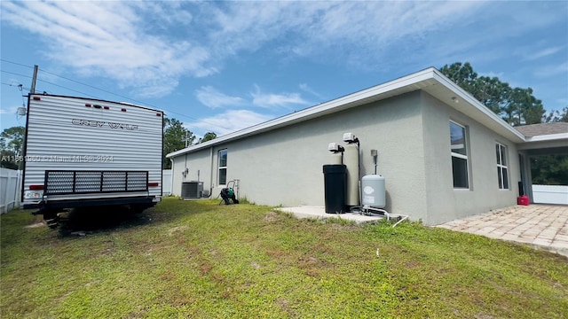 view of property exterior with a yard and cooling unit