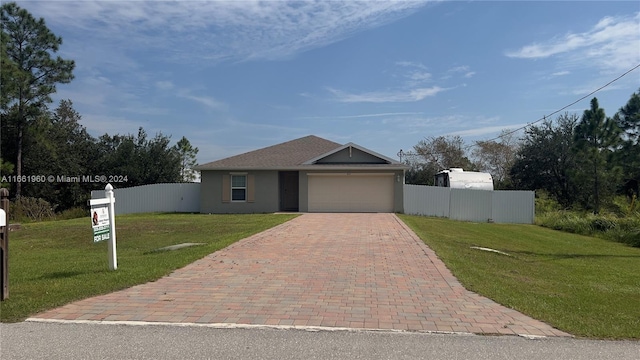 view of front of home with a front yard and a garage