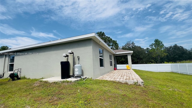 exterior space with a patio and a lawn