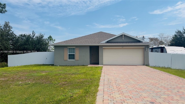 view of front of house featuring a front yard and a garage