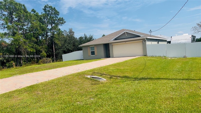 view of front facade with a front yard and a garage