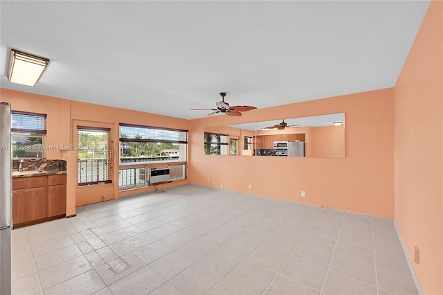 interior space with ceiling fan and light tile patterned flooring