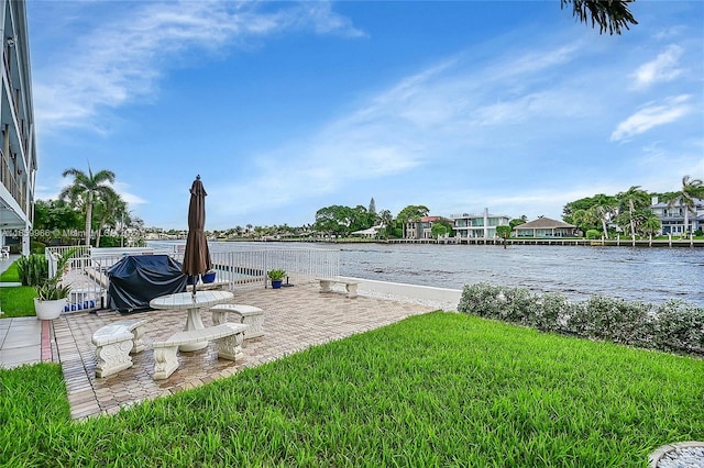 view of yard featuring a water view and a patio area