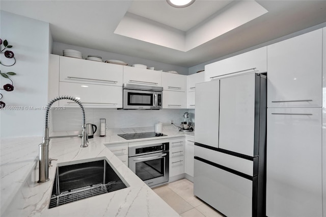 kitchen featuring white cabinets, sink, and appliances with stainless steel finishes