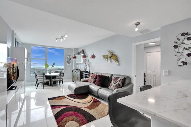 tiled living room with expansive windows