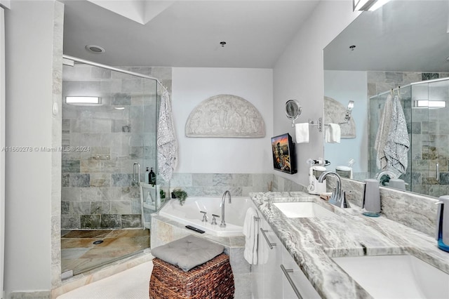 bathroom with shower with separate bathtub and vanity