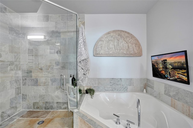 bathroom with separate shower and tub